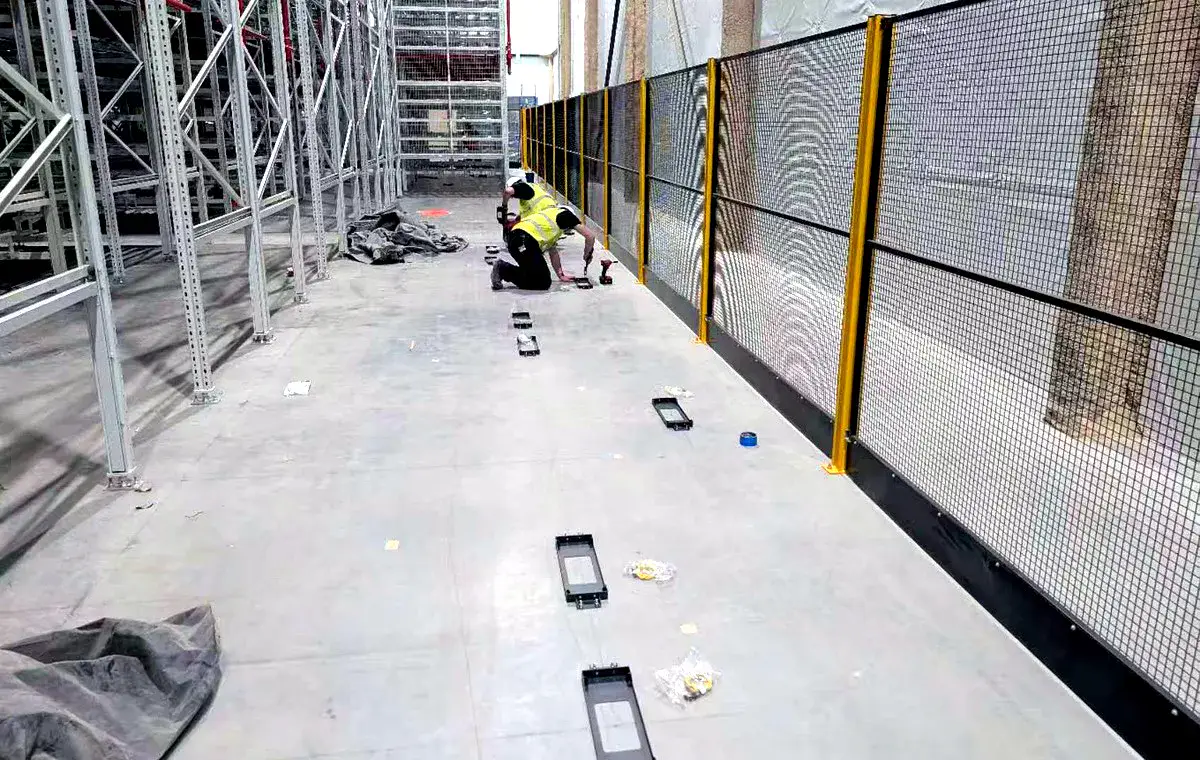 Field engineer installing and checking robot floor infrastructure